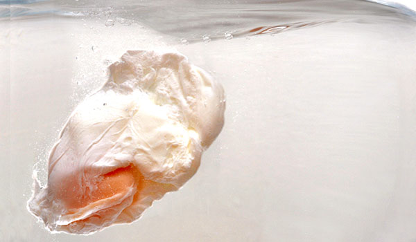 What is food poaching and what types of foods can be cooked using this technique?
