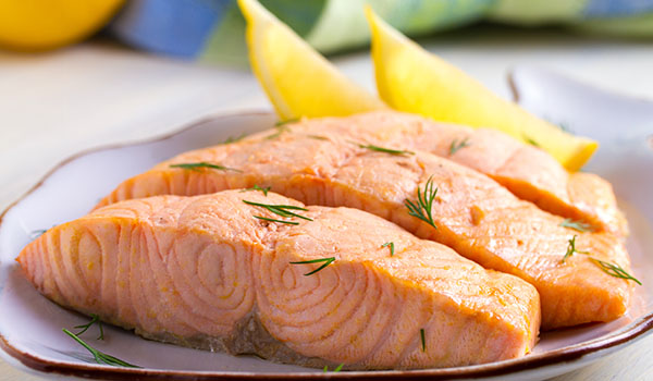 What is food poaching and what types of foods can be cooked using this technique?