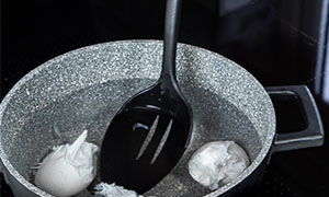 What is food poaching and what types of foods can be cooked using this technique?